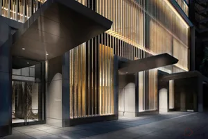 A modern commercial entryway featuring metallic and glass materials.