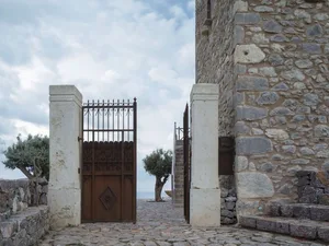 A minimalist stone gate in a landscape setting.