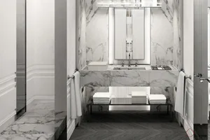 A modern bathroom interior featuring marble countertops and flooring.