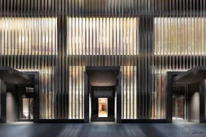 A modern lobby featuring metal walls and windows.