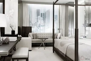 A minimalist bedroom with white fabric furniture, glass window, and wooden bed frame.