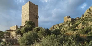 Stone castle towers and ruins on a hillside