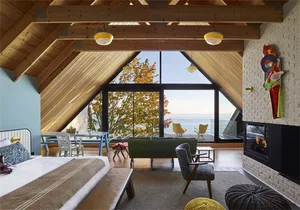 Modern bedroom featuring a sea view and wood elements.