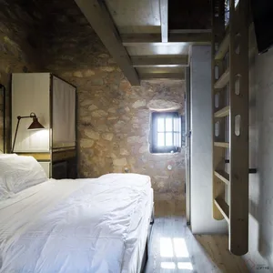 Minimalist bedroom with stone, wood, and metal elements.