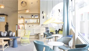 A modern coffee shop interior with bright lighting and mixed materials.