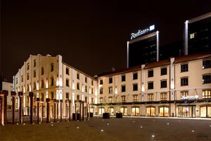 Night view of hotel exterior with brick, metal, and glass