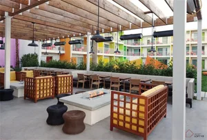 Outdoor patio area with industrial-style furniture and hanging lights