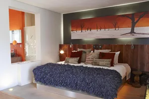 Modern, minimalist bedroom featuring wood-textured bedding and a wooden headboard.