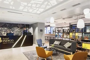 Modern hotel lounge with concrete floor and glass ceiling