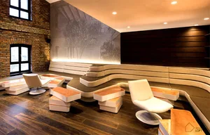 Modern office reception desk featuring comfortable seating and soft furnishings.