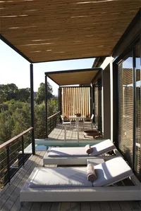 A modern terrace featuring wooden structures and furniture.