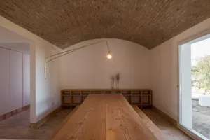Minimalist kitchen featuring wooden countertops and brick ceiling