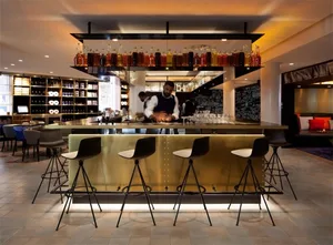 Modern bar counter featuring metal material with a sleek design in an interior setting.