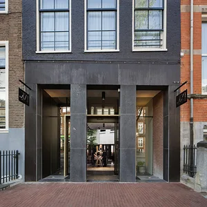 Modern storefront with brick walls, glass doors, and metal accents