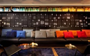 Modern living room featuring a comfortable couch adorned with colorful pillows.