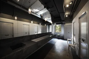 Modern public space featuring concrete, glass, and steel materials and design elements.