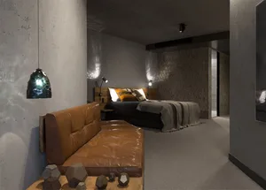 Modern industrial bedroom with concrete walls, wooden bed frame, and leather couch