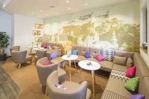 A cozy, modern cafe with comfortable seating and decorative accents.