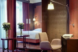 Modern hotel room featuring a textured paper wall and contemporary furniture.