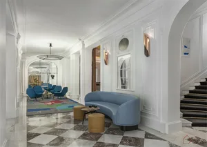 A modern lobby featuring marble floors and leather furniture