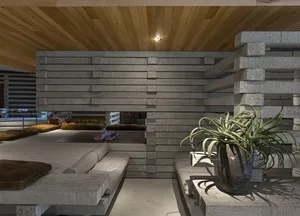 Concrete living room with industrial design elements and minimalist furniture.