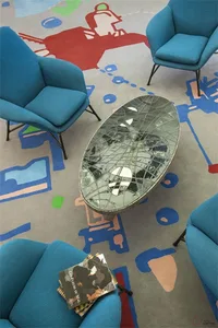 Modern living room with teal fabric armchairs and a circular coffee table.