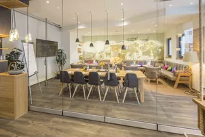 A modern office space featuring a wooden desk and seating arrangements
