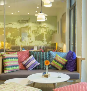 A cozy lounge area with a variety of colorful, patterned throw pillows on a comfortable sofa.