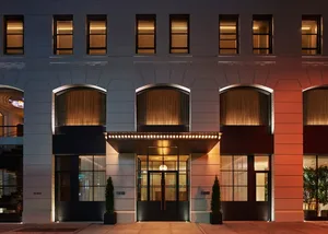 Modern hotel entrance featuring brick and concrete materials.