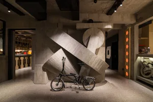 A modern industrial interior design featuring concrete and minimalist elements.