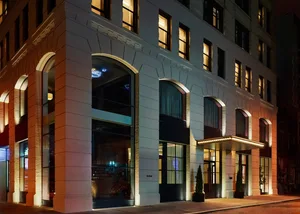 Modern building exterior with concrete, glass, and metal details.