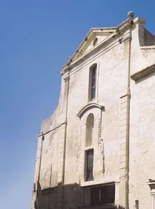 A building exterior made of granite with architectural details.
