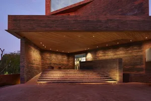 Industrial-style lobby with brick walls and a wooden ceiling.