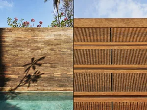 A modern wooden wall with a patterned design and a flower in front of it.