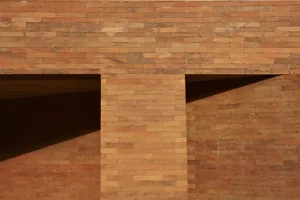 A modern building exterior constructed from red bricks.