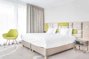 Modern minimalist bedroom with a soft, neutral textile color palette.