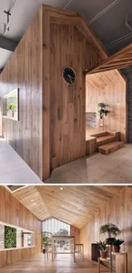A minimalist interior designed with wooden elements, featuring an open space with plants, a clock on a wall, and a high ceili