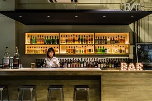 A well-stocked bar with bottles of alcohol lined up on shelves
