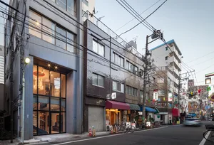 Modern street view of a building in Tokyo, featuring contemporary architecture and urban design.