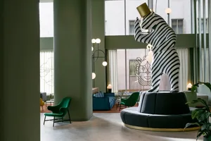 A modern lobby featuring a striking black and white striped tower sculpture.