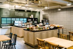 Industrial restaurant kitchen with breakfast options displayed on a counter.