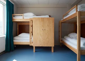 Minimalist bedroom featuring wooden bunk beds with white bedding and a blue floor.
