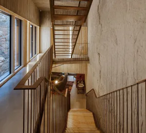 Modern interior design featuring concrete and wooden elements.