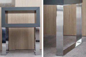A close-up of a modern interior furniture piece showcasing a sleek, minimalist metal frame with a distinctive grey rectangula