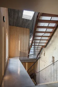 A modern interior design featuring wooden and concrete materials.