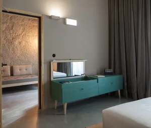 Modern industrial-style bedroom featuring concrete floor, concrete furniture, and minimalist design.