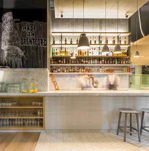 Modern bar interior with concrete walls, wooden accents, and glass countertops