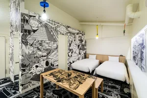 Modern hotel room with twin beds and colorful, abstract mural walls