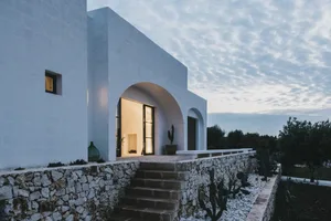 Modern minimalist residential home with a white concrete stone wall