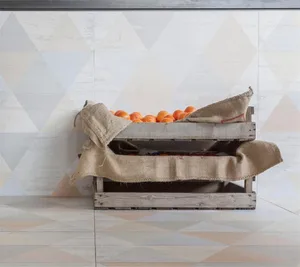 Wooden crates filled with oranges in a kitchen storage area featuring a wabi-sabi design aesthetic.